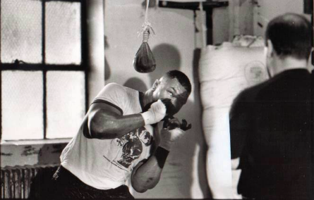 Mike Tyson using the slip bag with Kevin Rooney looking on. Tyson loved the slip bag for its ability to make him move his head and counter. 